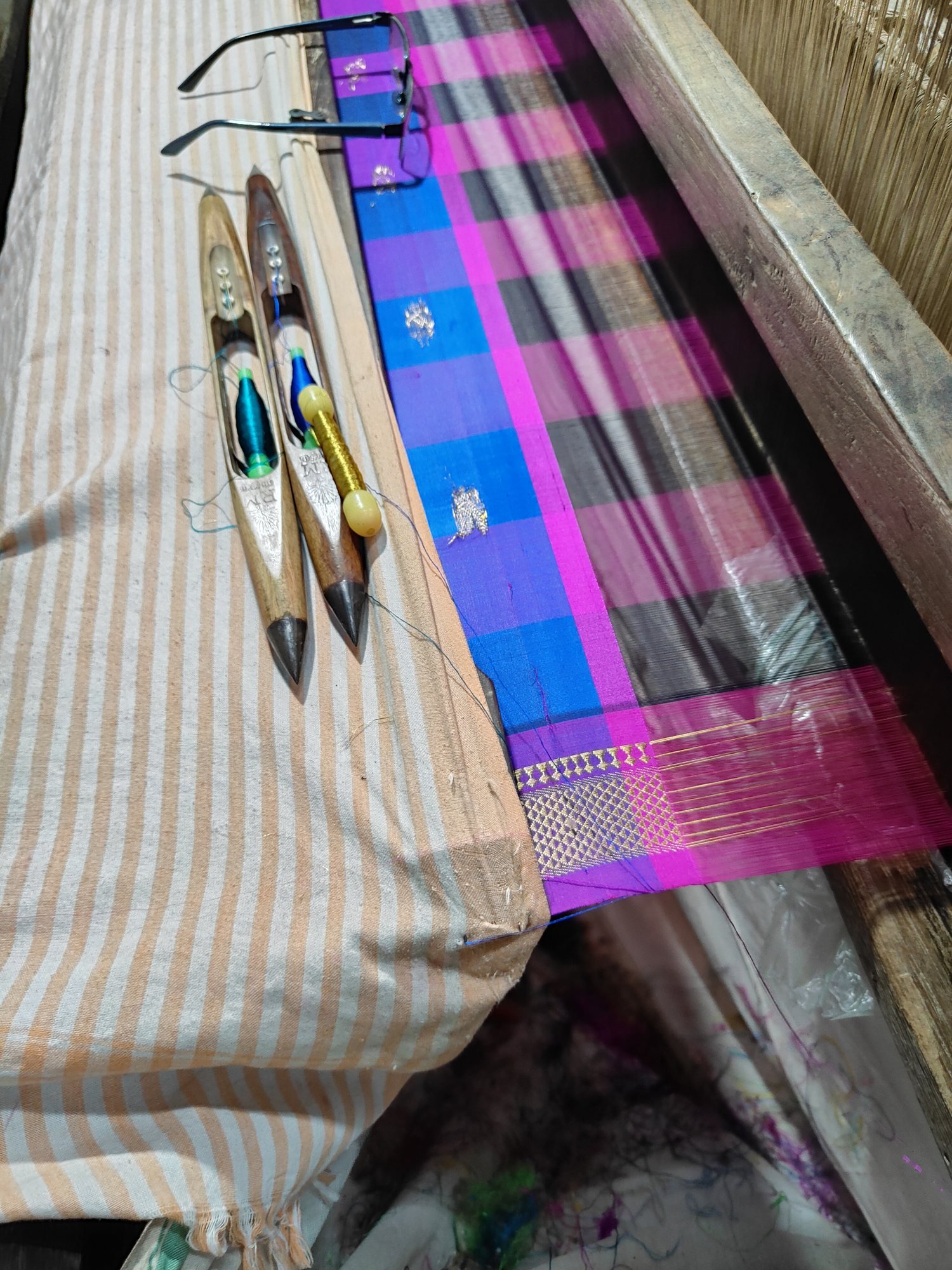 Silk shuttle and saree detail on the loom